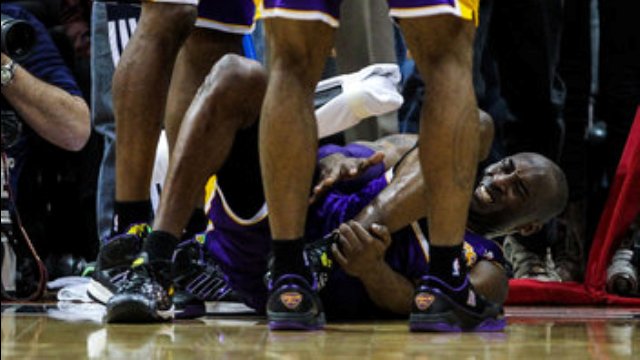 Mar 13, 2013; Atlanta, GA, USA; Los Angeles Lakers shooting guard Kobe Bryant (24) grabs his ankle before coming out of the game at the end of the second half against the Atlanta Hawks at Philips Arena. The Hawks won 96-92. Mandatory Credit: Daniel Shirey-USA TODAY Sports