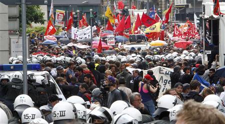 Riot police stand guard in front of protesters during an anti-capitalism "Blockupy" demonstration in Frankfurt