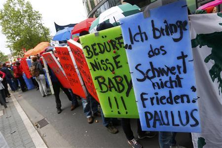 Protesters hold posters during an anti-capitalism "Blockupy" demonstration in Frankfurt