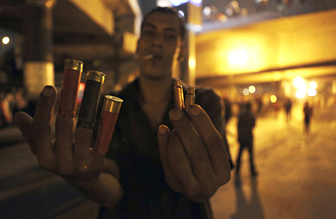 Anti-Mursi protester shows spent shell casings and rubber bullets during clashes with members of the Muslim Brotherhood and supporters of Mursi near Maspero, near Tahrir square in Cairo