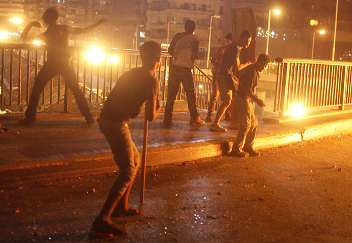 Protesters, who are against former Egyptian President Mohamed Mursi, demonstrate near pro-Mursi supporters, near Tahrir Square in Cairo