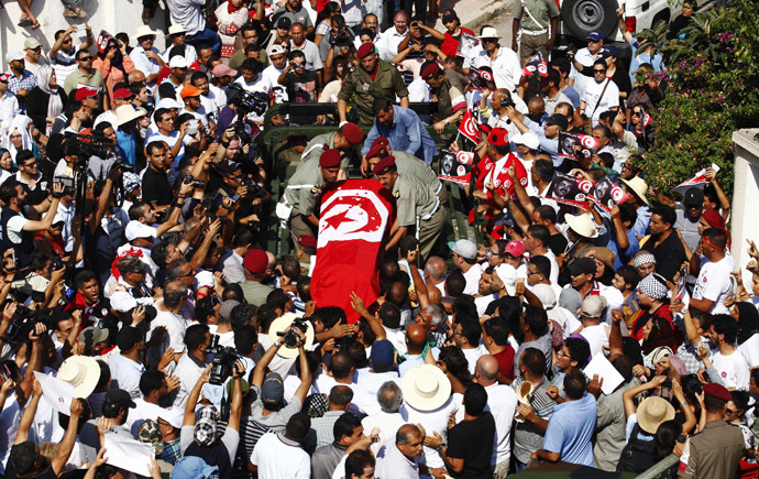 Mourners carry the coffin of slain opposition leader Brahmi during his funeral procession in Tunis