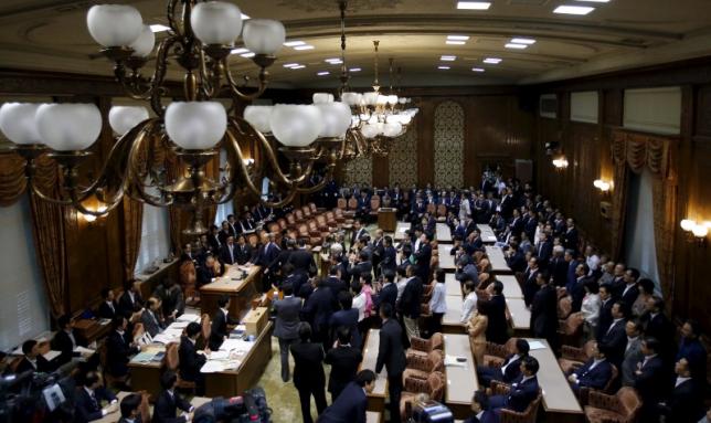 Opposition lawmakers stand around Konoike, chairman of the upper house special committee on security, at an upper house special committee session on security-related legislation at the parliament in Tokyo