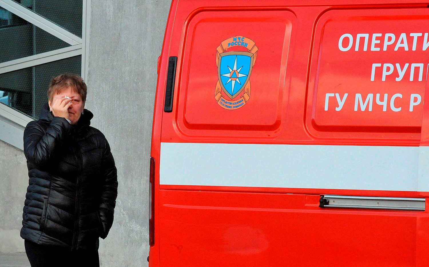 A woman wipes her tears outside Pulkovo