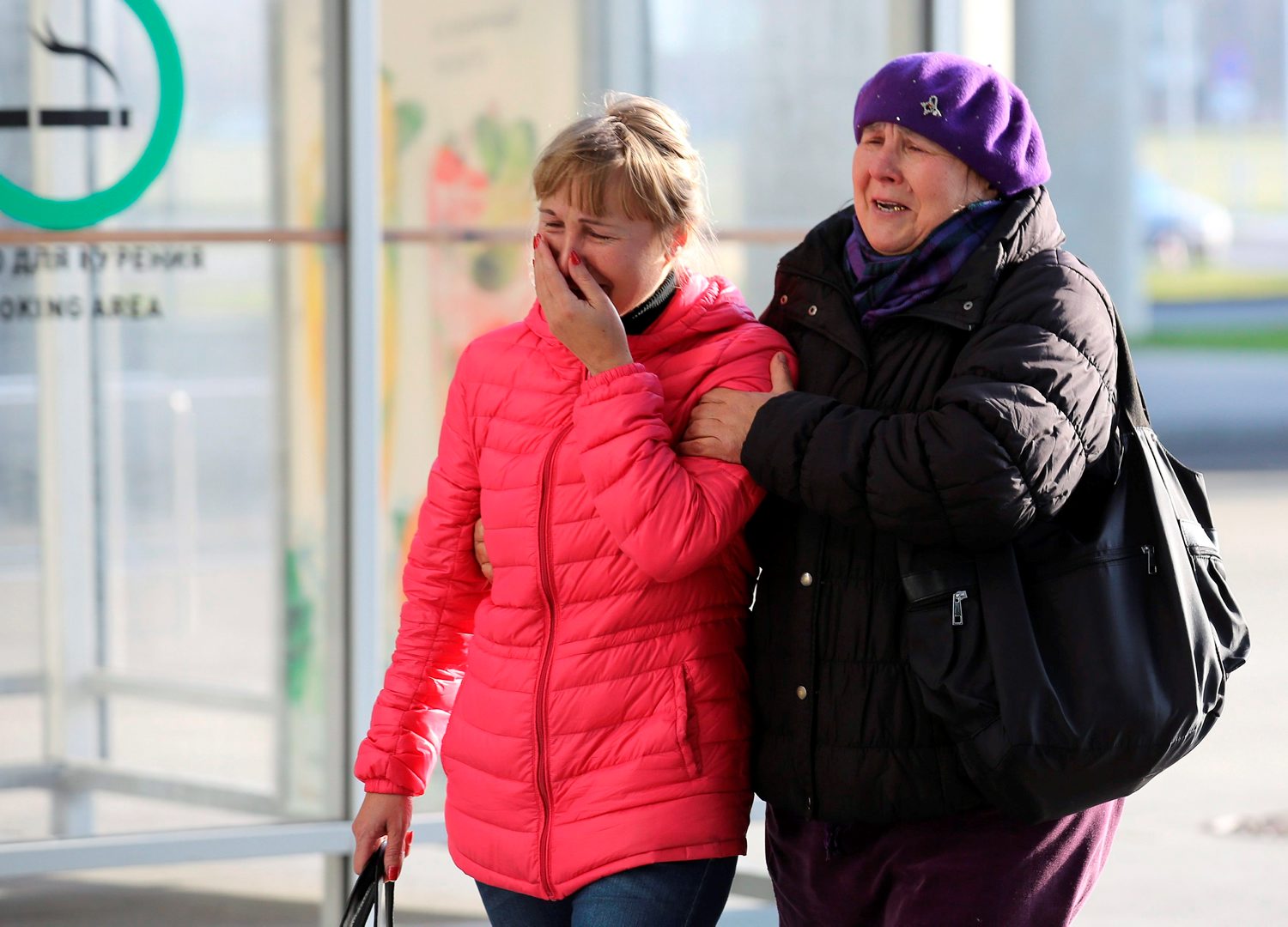 Women react as they walk at Pulkovo airport in St. Petersburg, Russia REUTERS/Peter Kovalev