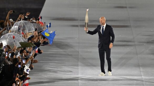 epa11498100 Zinedine Zidane carries the Olympic flame torch at Trocadero during the Opening Ceremony of the Paris 2024 Olympic Games, in Paris, France, 26 July 2024.  EPA-EFE/Joel Marklund / POOL